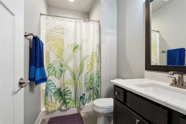 bathroom featuring curtained shower, hardwood / wood-style floors, vanity, and toilet