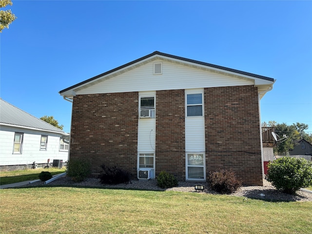 view of side of home with a yard