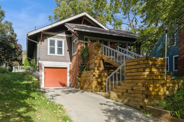 view of front of house with a front yard and a garage