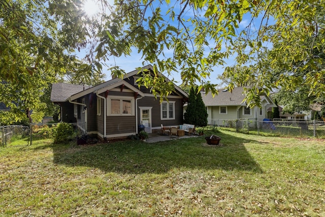 rear view of property with a lawn and a patio