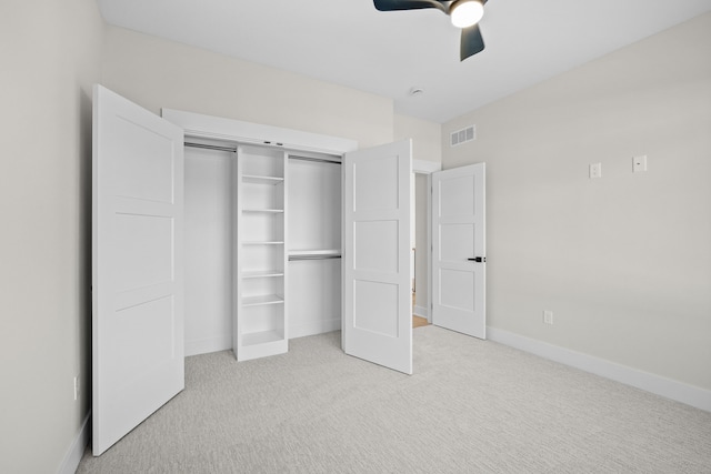 unfurnished bedroom featuring light carpet, baseboards, visible vents, ceiling fan, and a closet