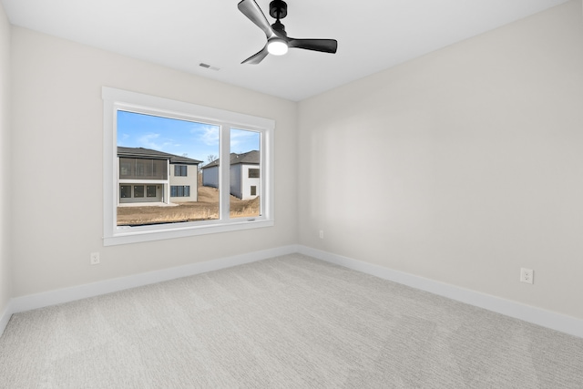 unfurnished room featuring carpet floors, visible vents, and baseboards