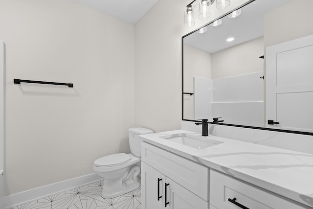 full bath featuring toilet, vanity, and baseboards