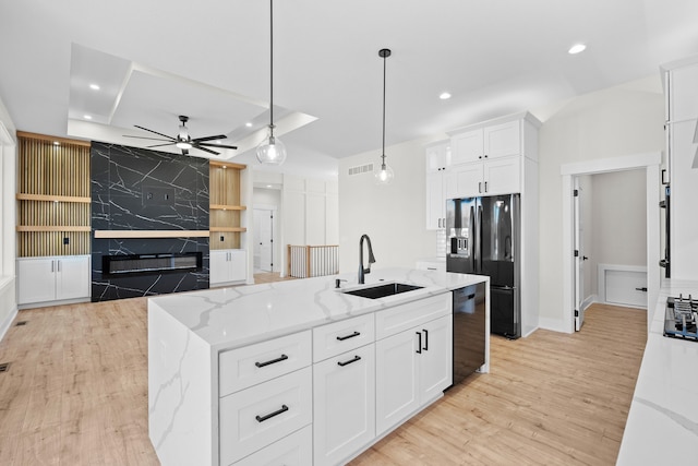 kitchen featuring recessed lighting, visible vents, a sink, and black appliances