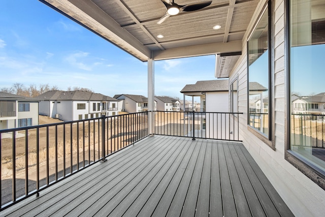 wooden deck featuring a ceiling fan and a residential view