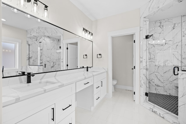 bathroom with toilet, a sink, a marble finish shower, and double vanity