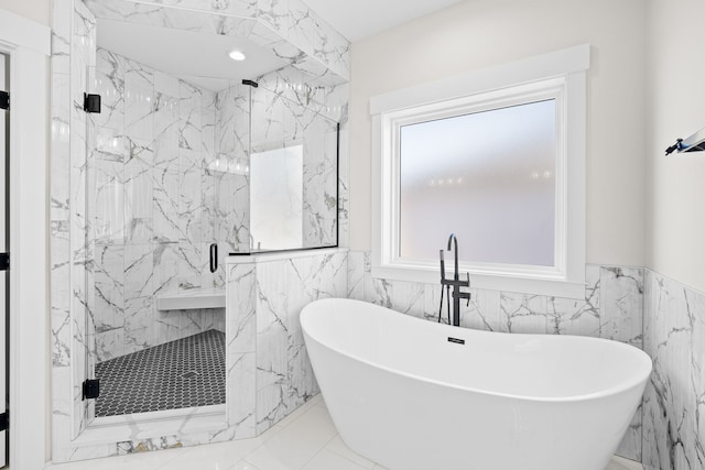 full bath with marble finish floor, a wainscoted wall, a freestanding bath, and a marble finish shower