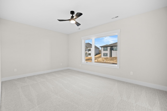 unfurnished room featuring ceiling fan, carpet flooring, visible vents, and baseboards