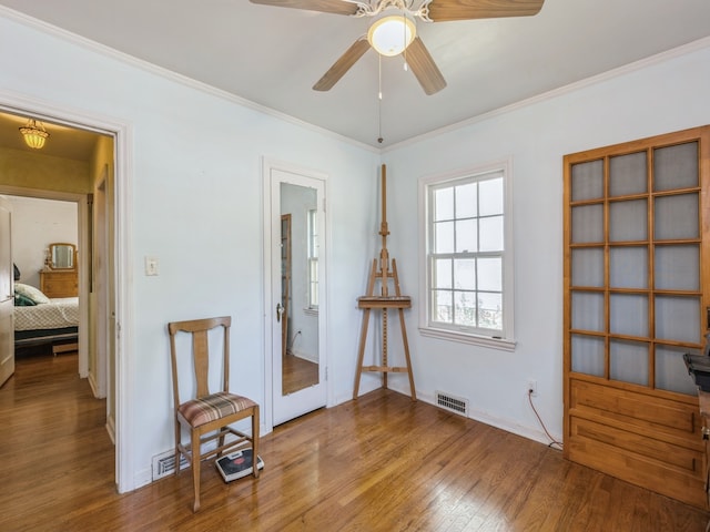 misc room featuring ceiling fan, ornamental molding, and hardwood / wood-style floors