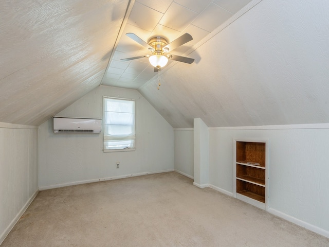 additional living space featuring ceiling fan, lofted ceiling, built in features, a wall mounted AC, and light carpet