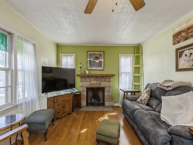 living room featuring a textured ceiling, light wood-type flooring, and a wealth of natural light