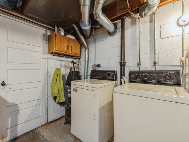 clothes washing area with separate washer and dryer