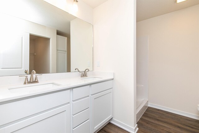 bathroom with hardwood / wood-style floors, vanity, and toilet