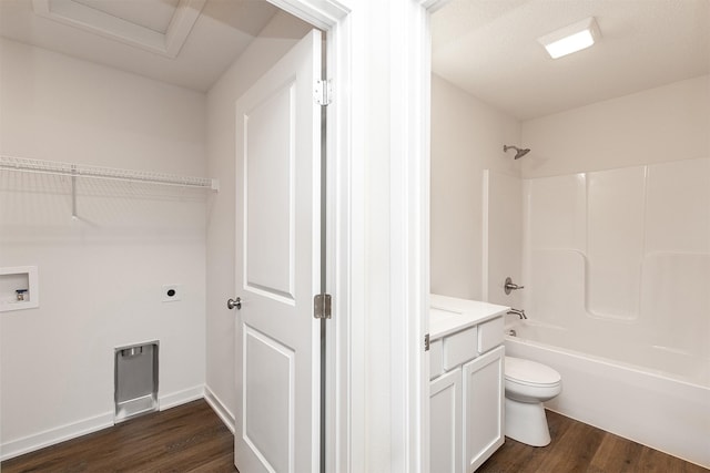 full bathroom featuring vanity, shower / tub combination, hardwood / wood-style flooring, toilet, and a textured ceiling