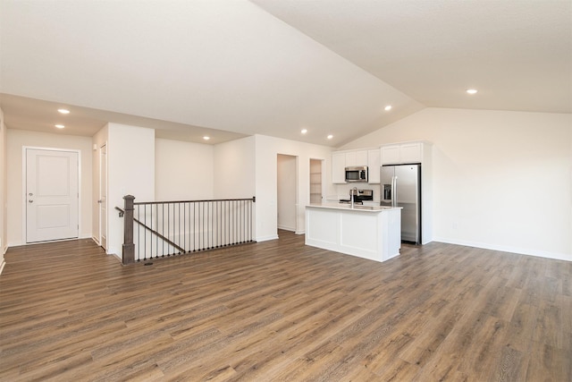 unfurnished living room featuring dark hardwood / wood-style flooring and lofted ceiling