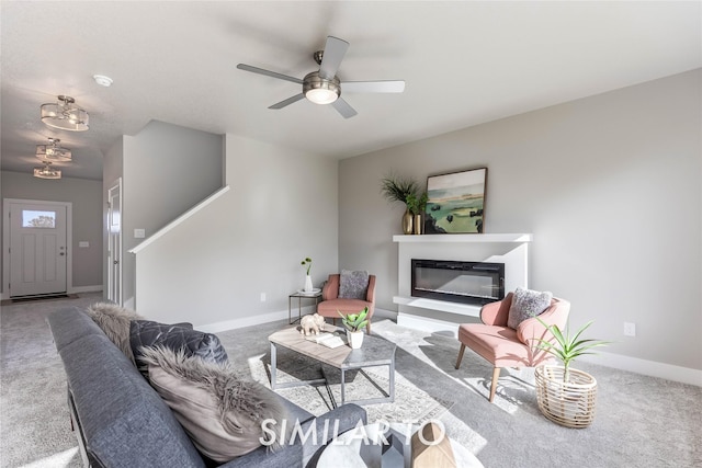 carpeted living room with ceiling fan