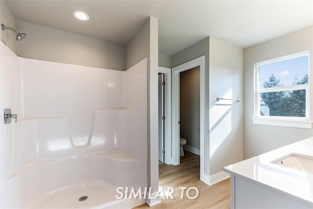 bathroom featuring vanity, toilet, and walk in shower