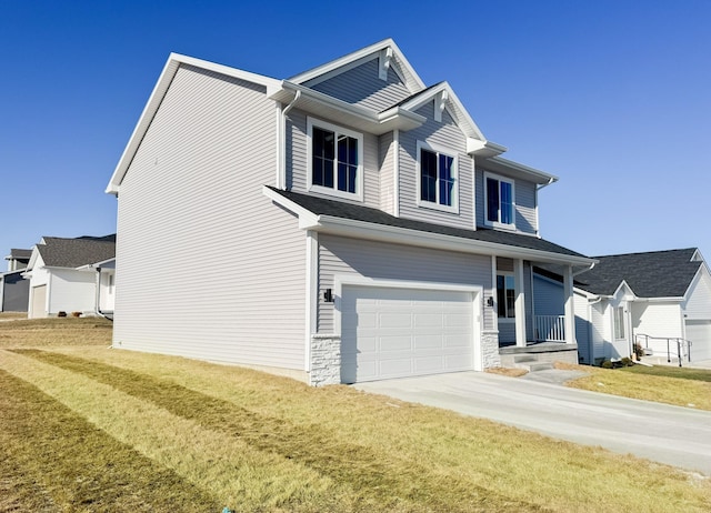 view of front of property with a garage and a front lawn