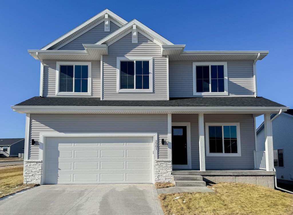 view of front of house featuring covered porch and a garage