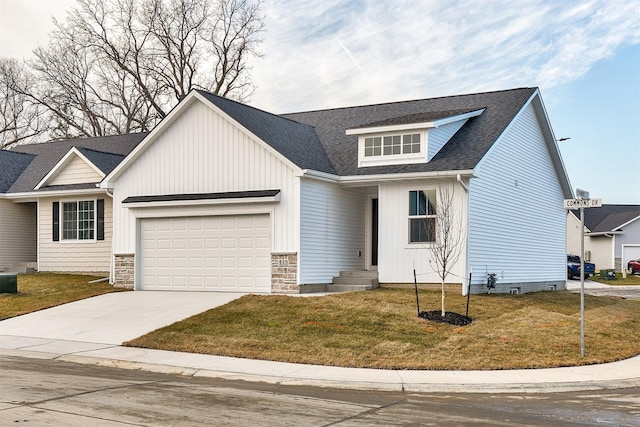 view of front of property with a front yard and a garage