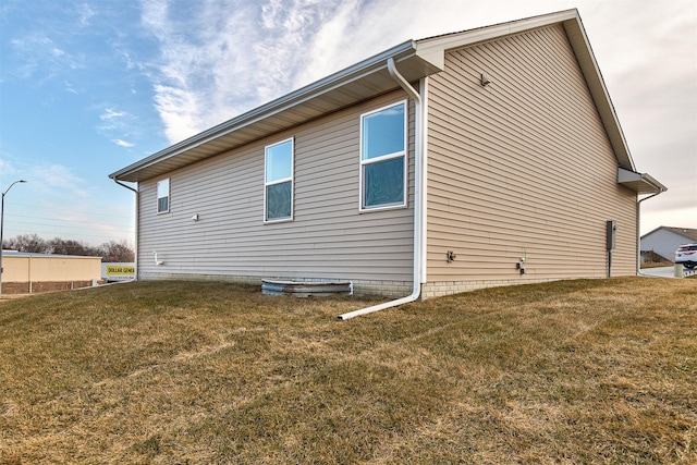 view of home's exterior with a yard