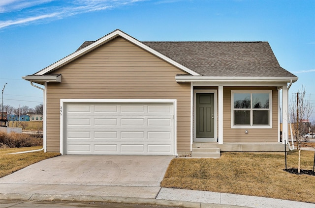 ranch-style house featuring a front yard and a garage