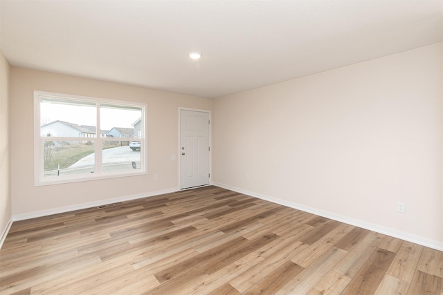 spare room featuring light hardwood / wood-style flooring