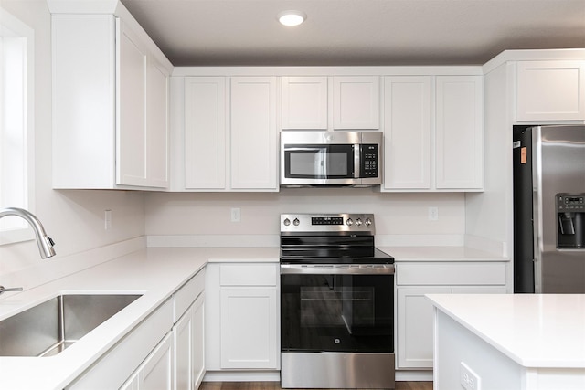 kitchen with sink, white cabinets, and stainless steel appliances