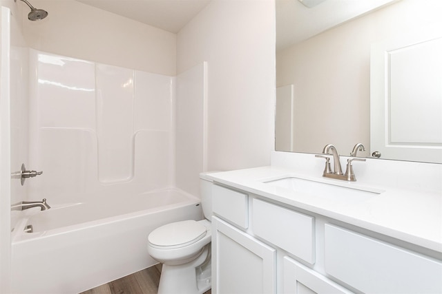 full bathroom with vanity, toilet, shower / bathing tub combination, and hardwood / wood-style flooring