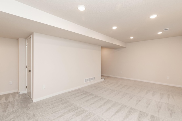 basement with light colored carpet