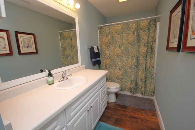 bathroom featuring vanity, toilet, a shower with shower curtain, and hardwood / wood-style flooring