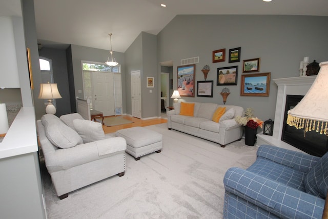 living room with high vaulted ceiling