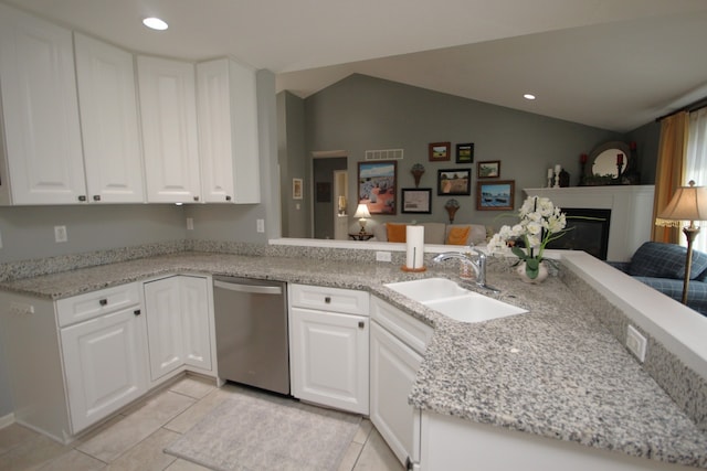 kitchen with dishwasher, sink, white cabinets, lofted ceiling, and kitchen peninsula