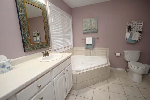 bathroom featuring a relaxing tiled tub, tile patterned flooring, vanity, and toilet