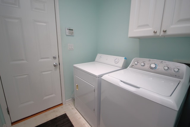 washroom featuring cabinets and separate washer and dryer