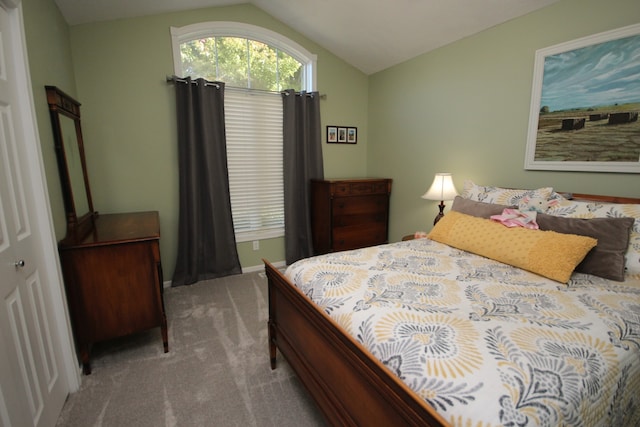 carpeted bedroom with vaulted ceiling