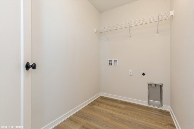 laundry area with hookup for an electric dryer, light wood-type flooring, and hookup for a washing machine