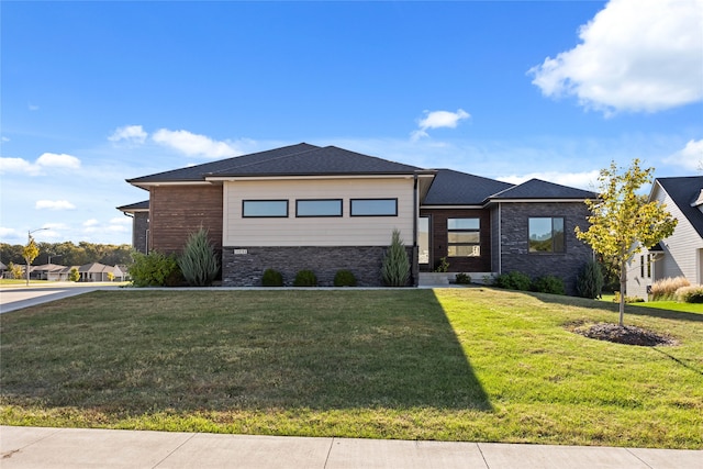 prairie-style home featuring a front lawn