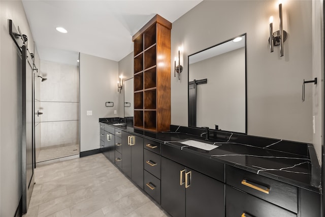 bathroom featuring vanity and a shower with door