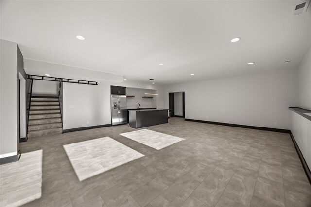 unfurnished living room with sink