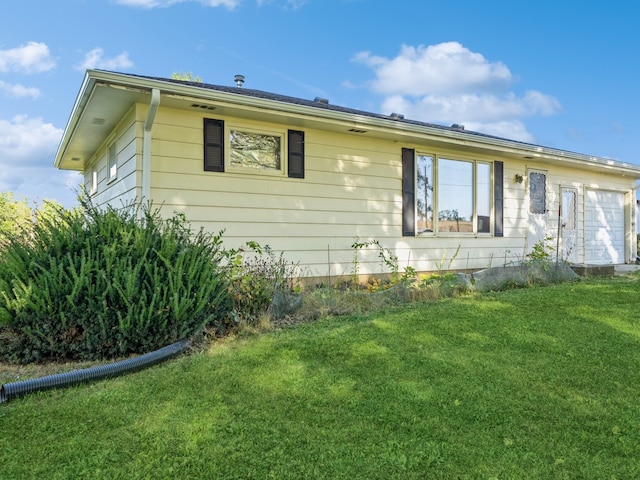 view of side of property with a yard