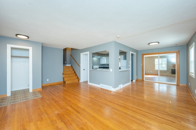 unfurnished living room with light wood-type flooring