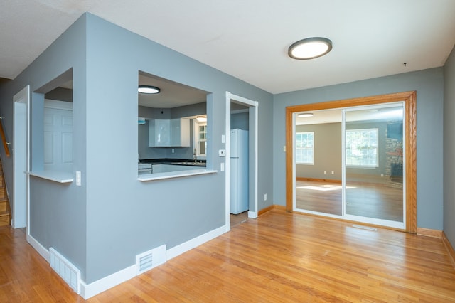 unfurnished living room with light hardwood / wood-style flooring