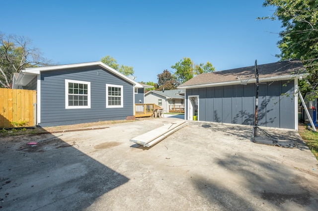 back of house featuring a deck and a patio area