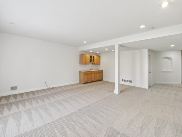 unfurnished living room featuring light carpet