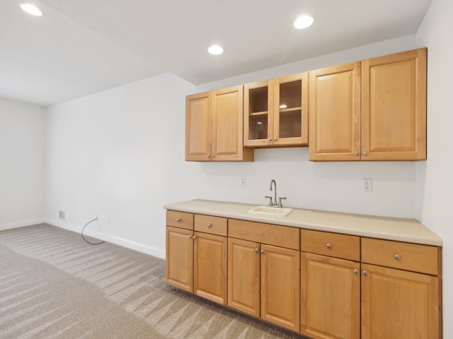 kitchen featuring light carpet and sink