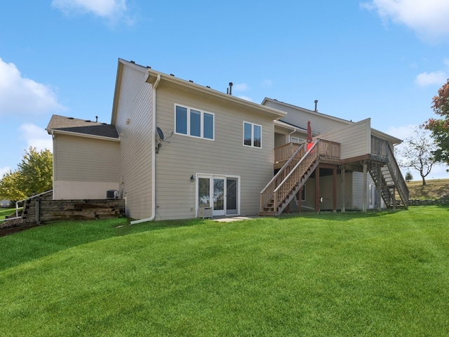 back of house featuring a wooden deck and a lawn