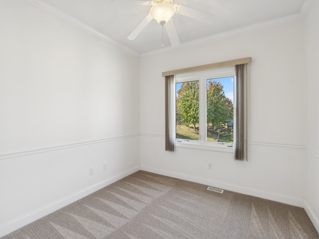 carpeted spare room with crown molding and ceiling fan