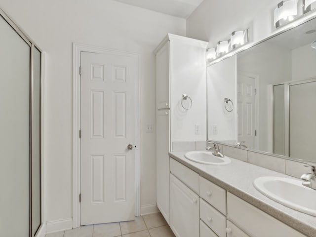 bathroom featuring vanity, a shower with shower door, and tile patterned floors