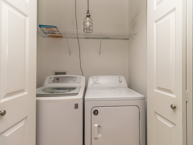 clothes washing area featuring washing machine and clothes dryer